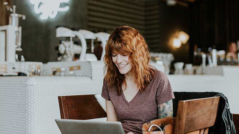woman using a laptop smiling