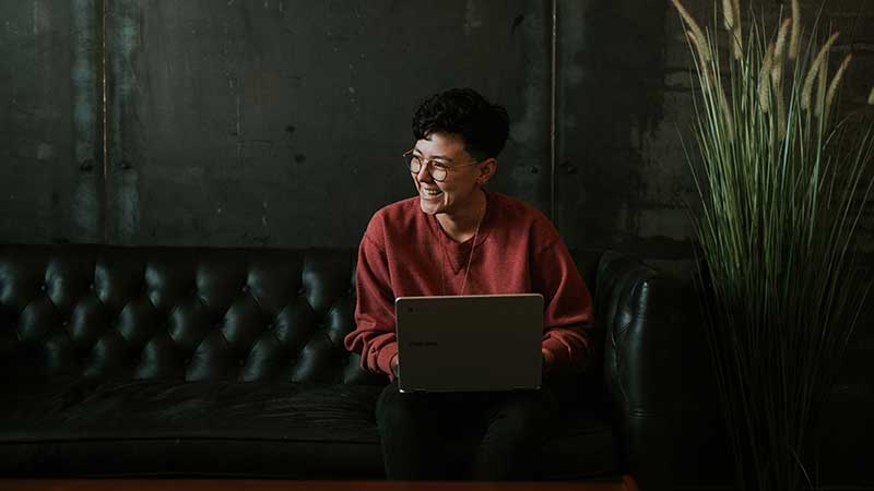 woman smiling using a laptop