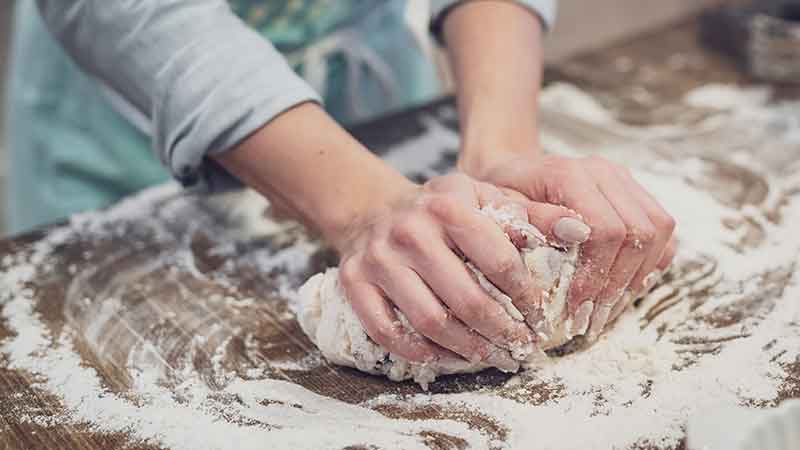 baker kneading dough