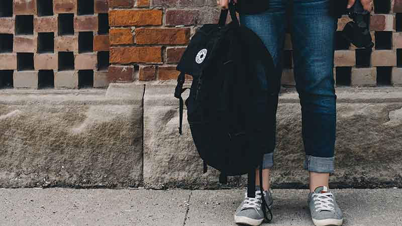 backpack affiliate programs - girl holding a backpack