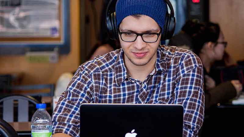 man reading on laptop