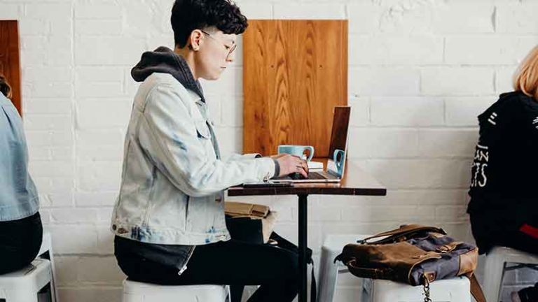 woman using laptop in a cafe