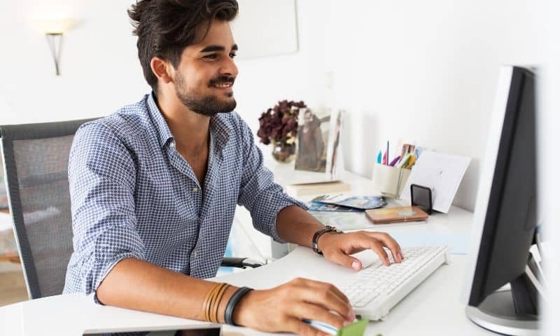 man typing a blog