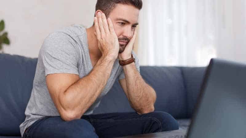 man reading his laptop