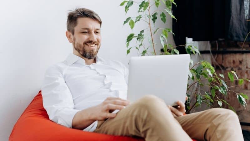 man sitting using a laptop